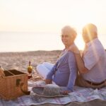 senior citizen couple enjoying picnic under sunlight to absorb natural vitamin D
