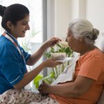 nursing staff helping senior citizen with post-surgery recovery